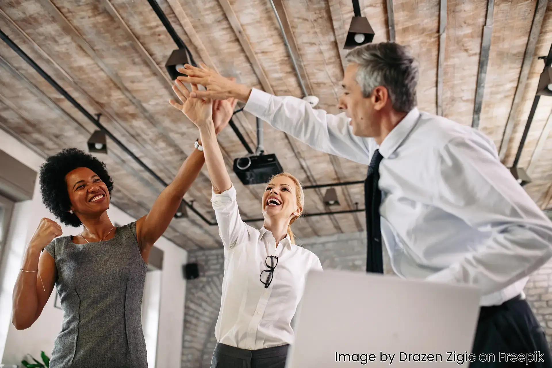 image of diverse business people high fiving