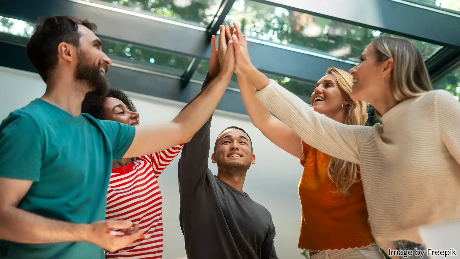 diverse young people high fiving